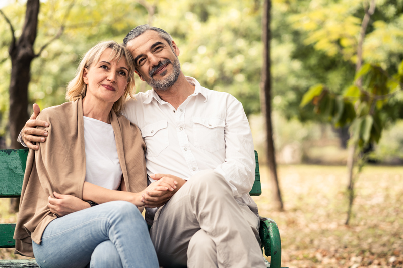 Couple sitting on a bench in Calgary enjoying the benefits of BHRT